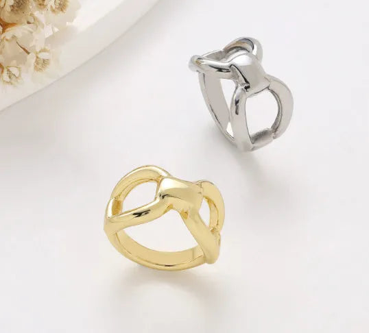 Titanium steel women's ring with hollow butterfly design and geometric bow shape in gold and steel colours