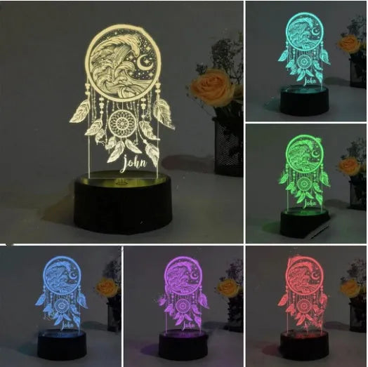 Black-based acrylic dream catcher night light with remote control on a table.