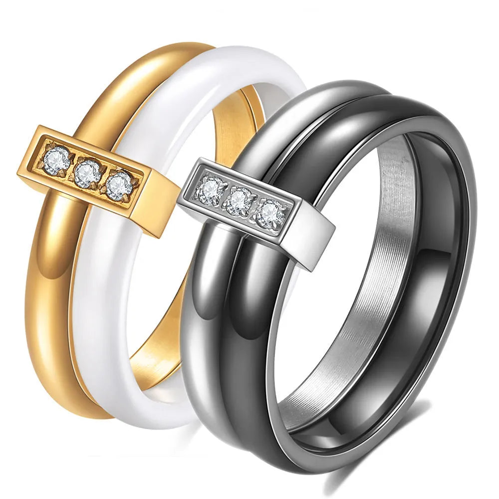 A Steel Black ceramic women's ring with glossy stitching and inlaid zirconium stones on a wooden surface.