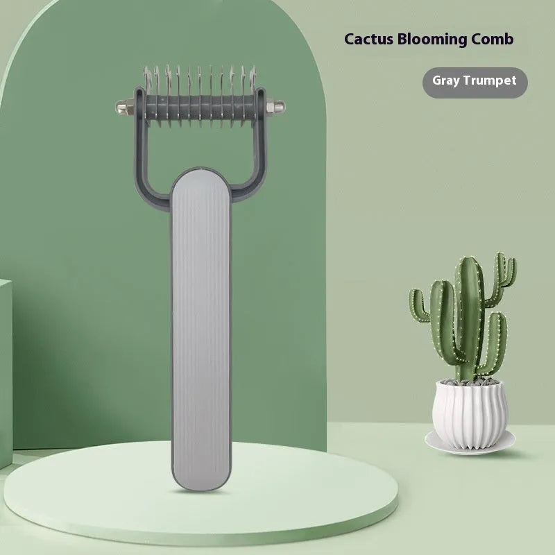 Green and grey dog grooming unknotting comb with stainless steel pins on a plastic handle.