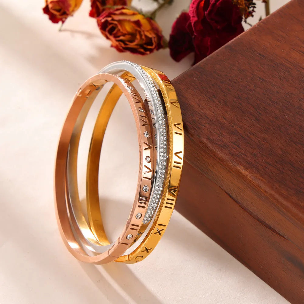 Retro Roman numeral titanium steel gold-plated bracelet with diamond accents on wrist