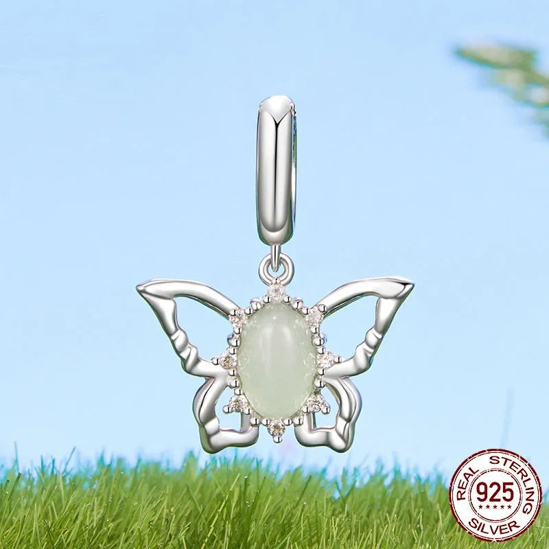 925 sterling silver butterfly pendant with green natural jade inlay on a white background