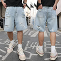 Men's light blue ripped denim shorts with a loose, straight leg fit on a plain background.