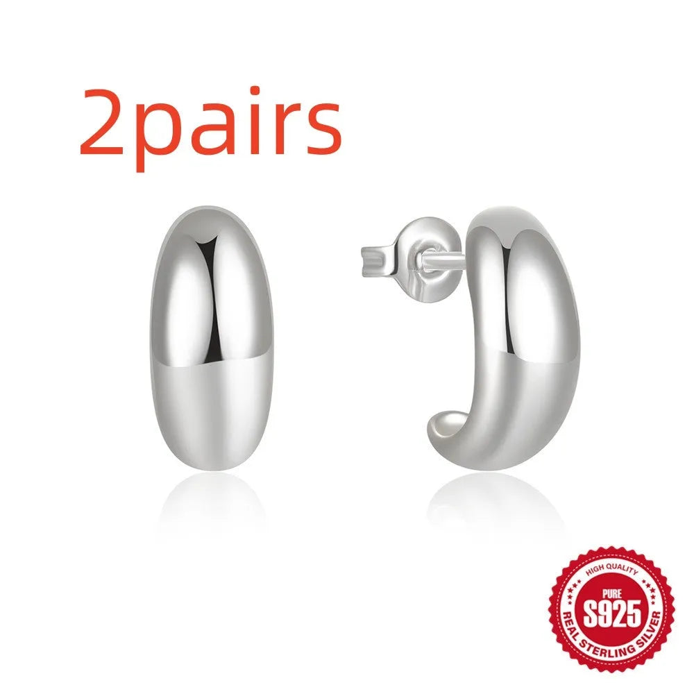 C-shaped sterling silver stud earrings with electroplated gold finish and post backing
