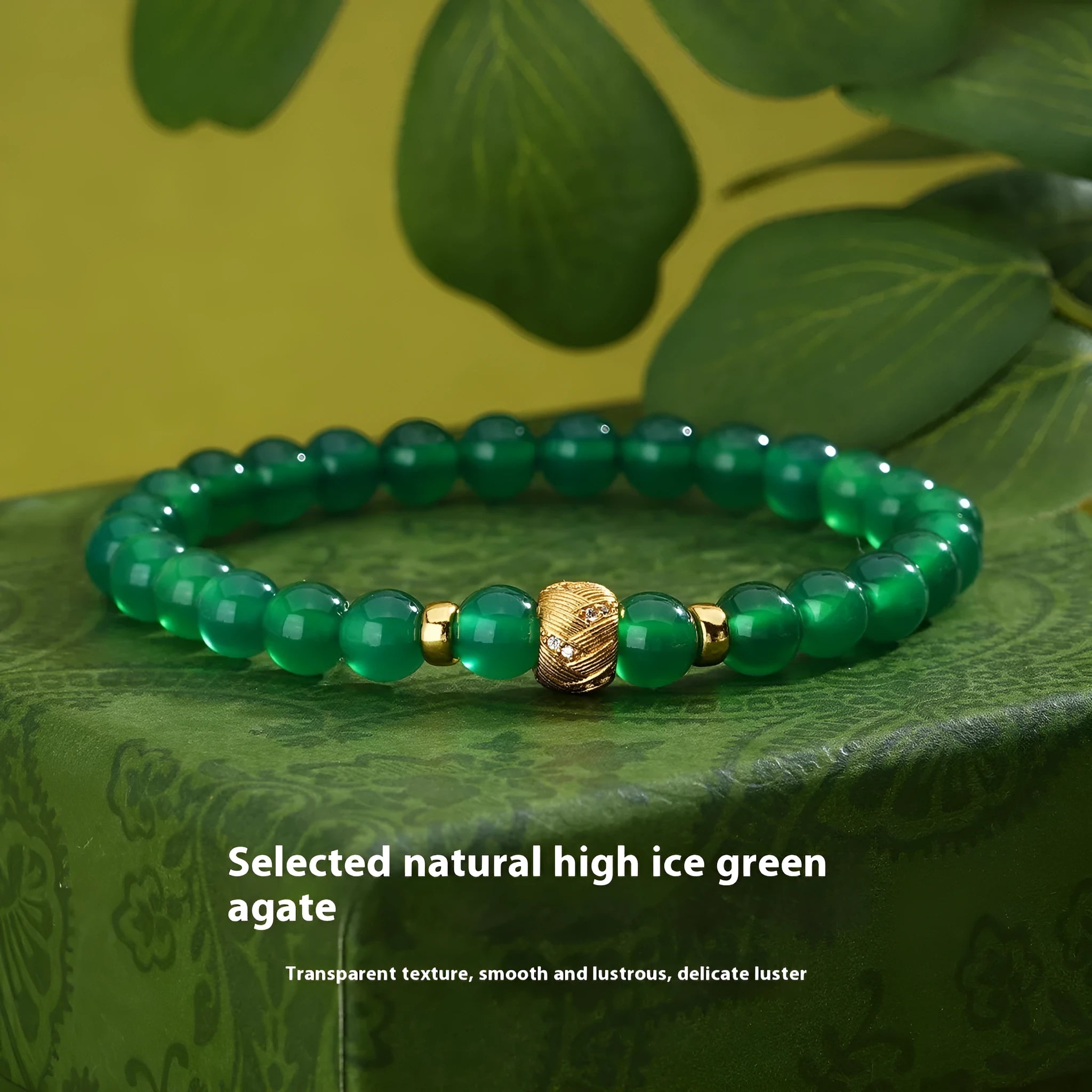 Close-up of a women's bracelet with a green agate stone on a two-tone silver and gold-plated chain.