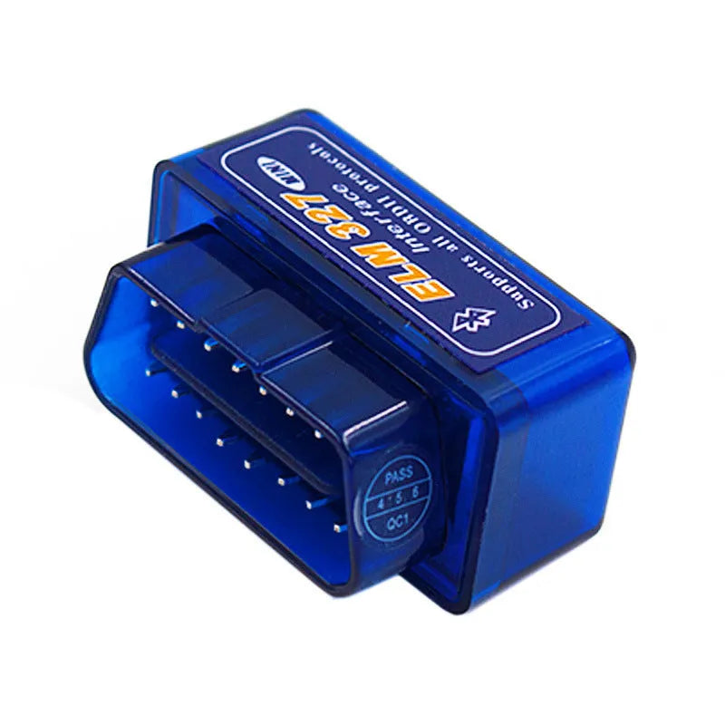 Small black ELM327 OBD2 Bluetooth diagnostic scanner next to a vehicle's OBD2 port.