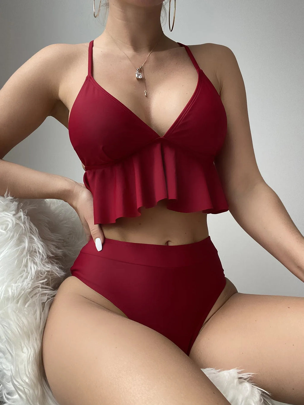 Women's solid colour high-waisted bikini with adjustable ties on the top.