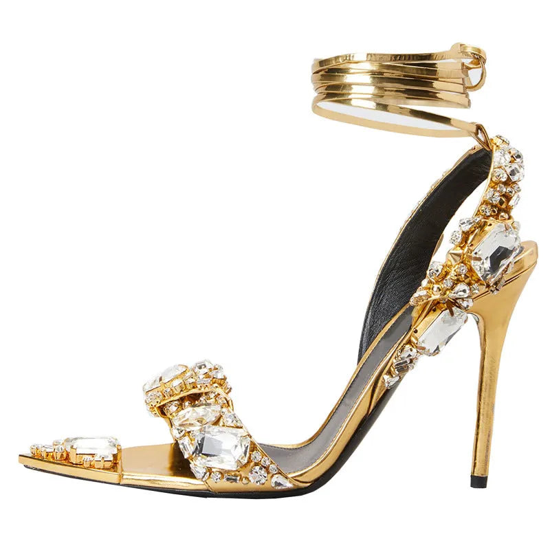 Super high heel pointed toe rhinestone slingback heels in gold on display