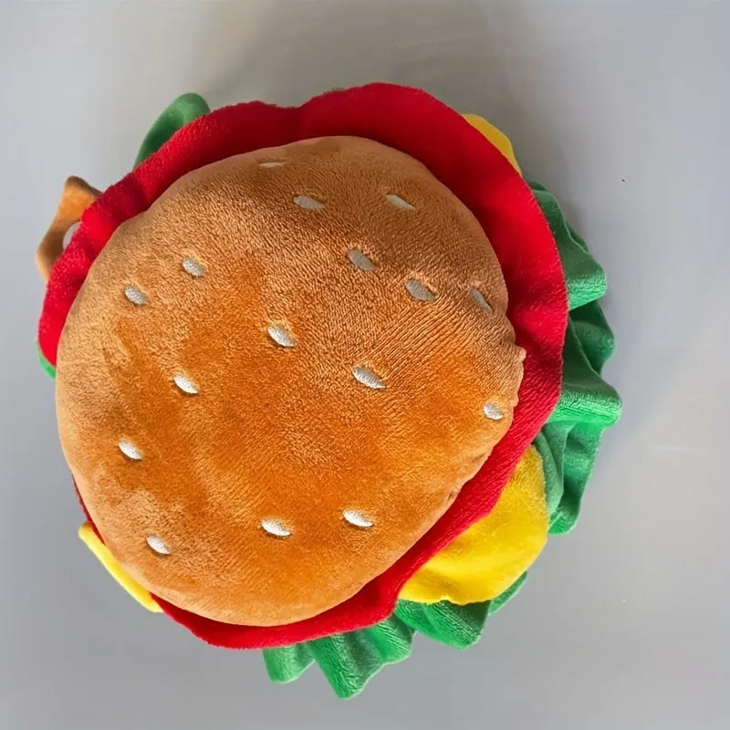 A soft burger bun headdress with a felt cheese slice for cats, shown with an adjustable neck strap.