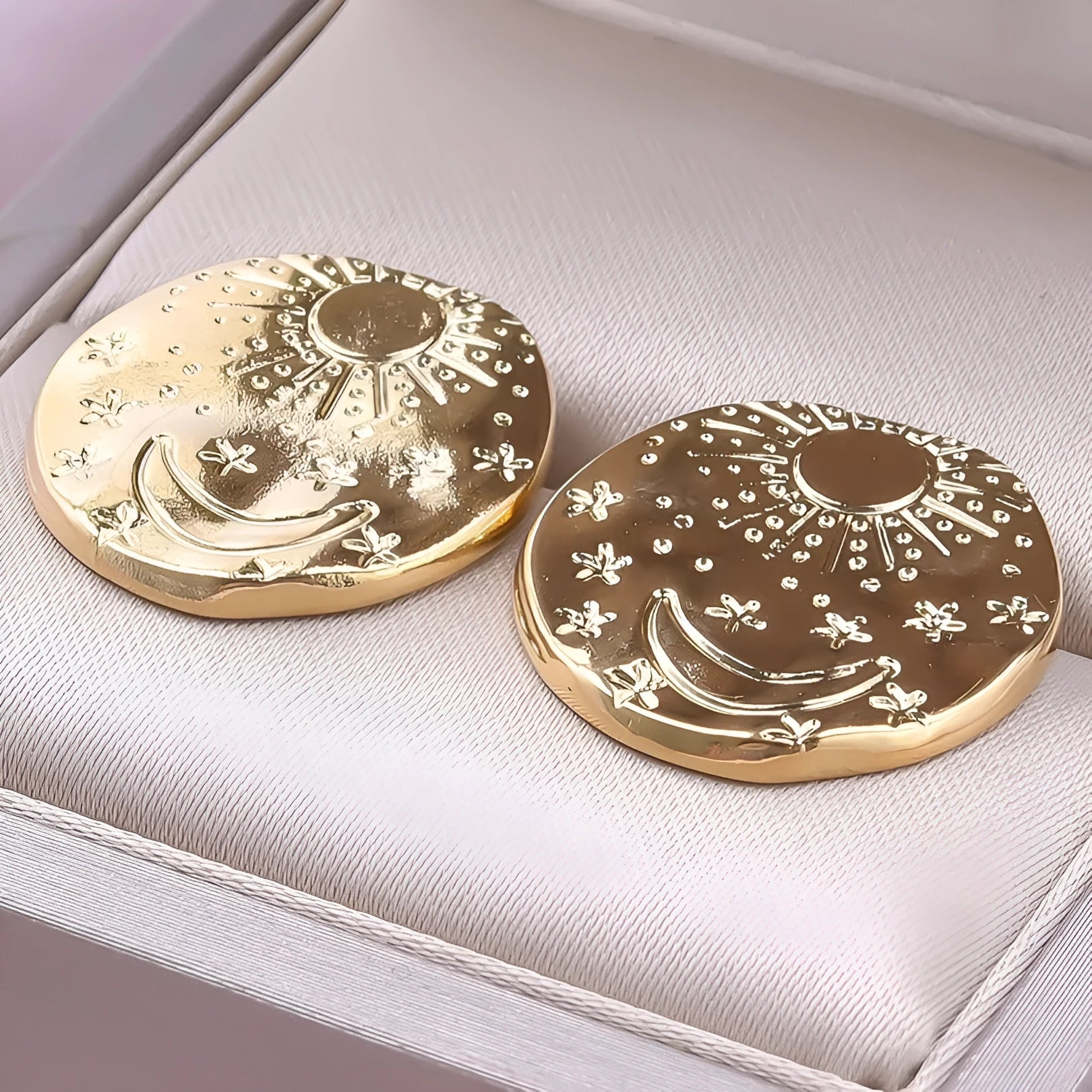 A pair of geometric 304 stainless steel ear studs with shell detailing, shown in a gold electroplated finish.
