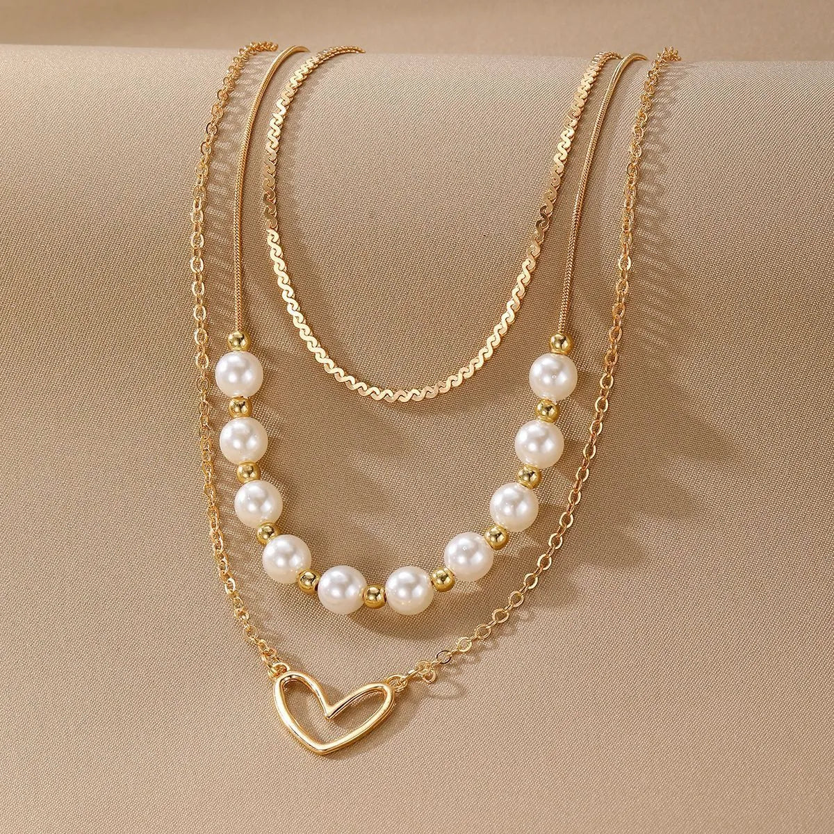 Gold tone heart-shaped pendant necklace with pearl chain, vintage love symbol jewellery