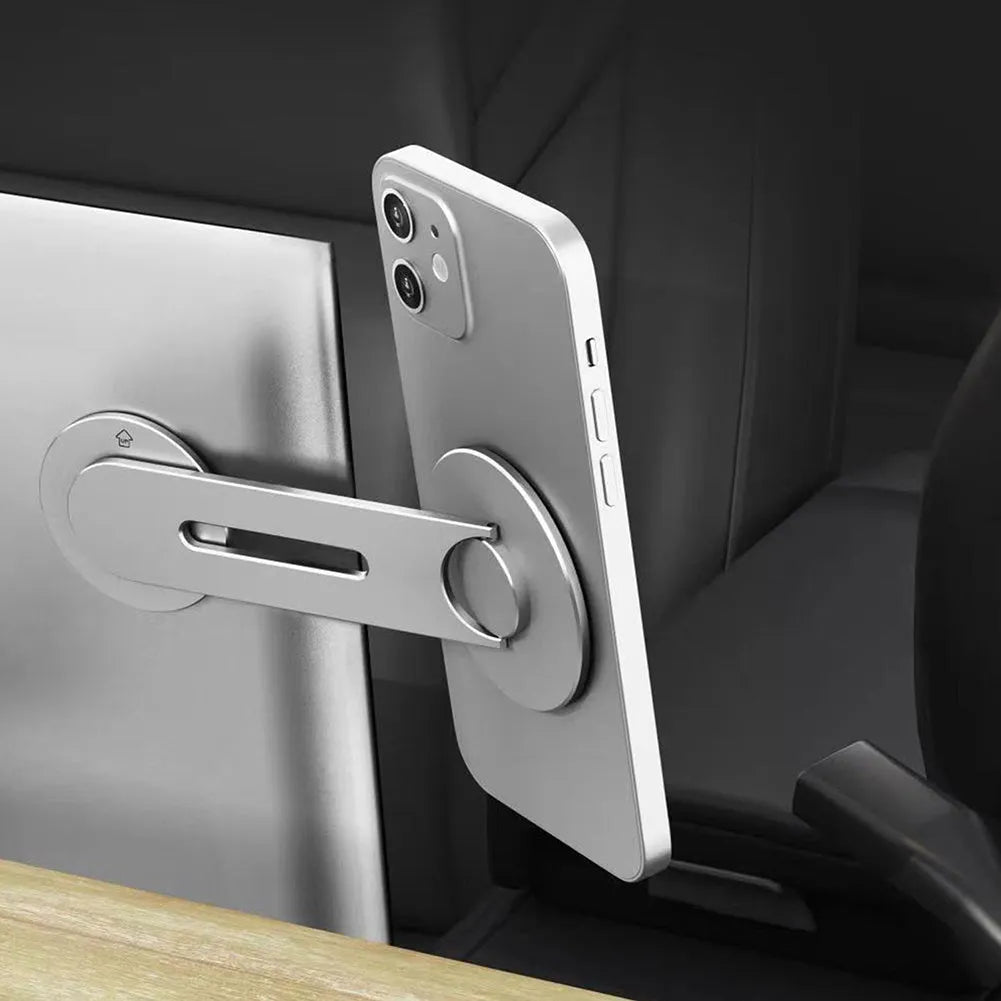 Silver magnetic phone holder mounted near Tesla suspension screen showing 180-degree flip mechanism