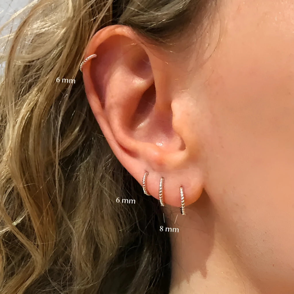 A pair of twisted sterling silver round ring earrings in a gold colour finish, shown at 13mm size.