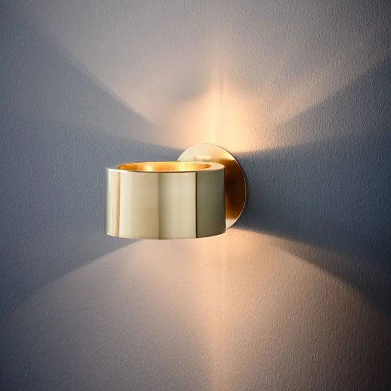 Modern iron wall lamp with copper gold finish, 15cm diameter on a white wall