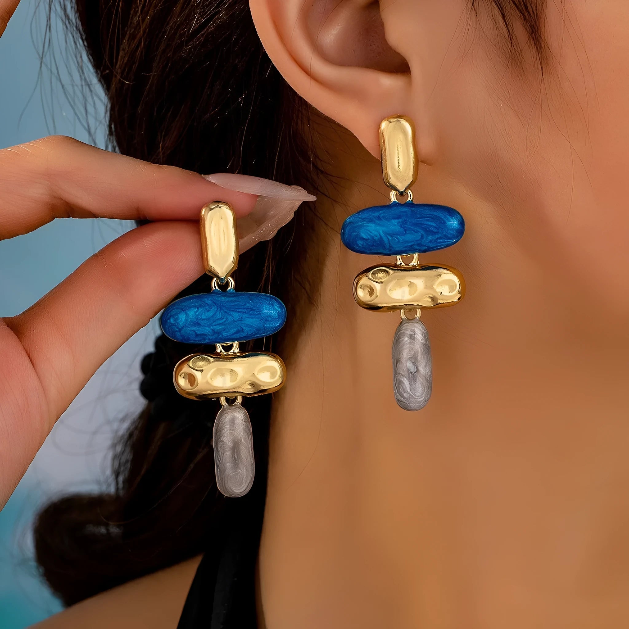 A pair of women's geometric stud earrings with a multicolour electroplated finish on a zinc alloy base.