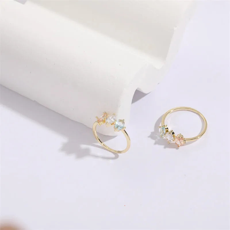 Mother's Day birthstone ring with geometric triangle design and horse eye tricolour zircon stones in 14k gold colour