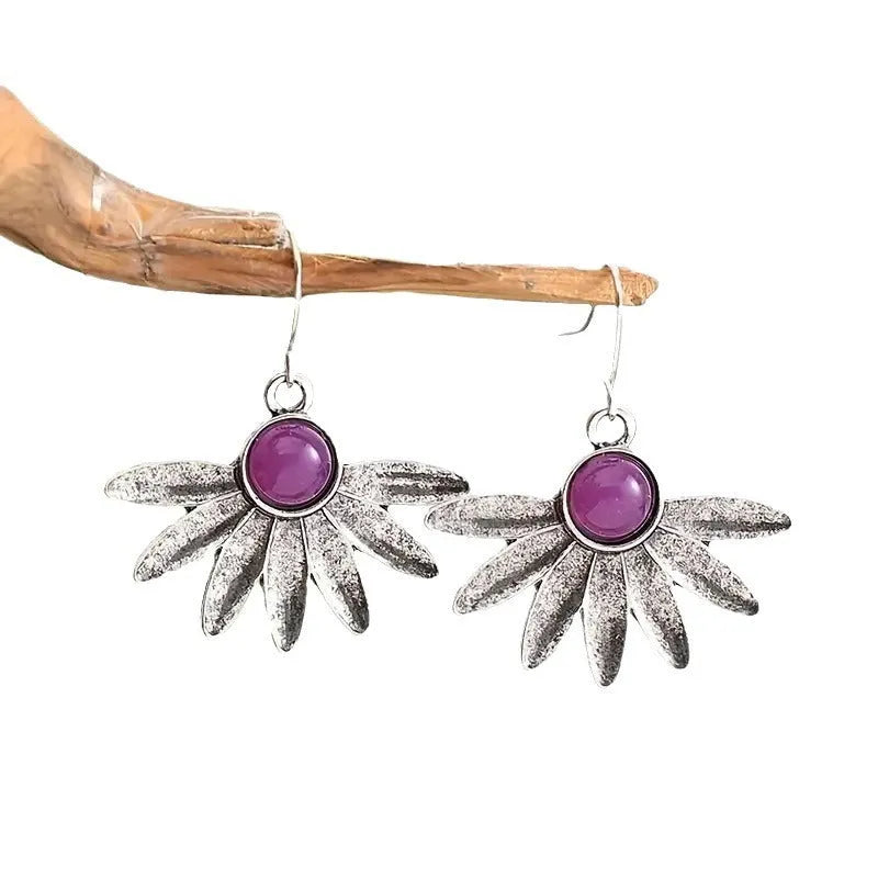 Purple Bohemian style earrings with floral and animal zodiac design in alloy and resin.