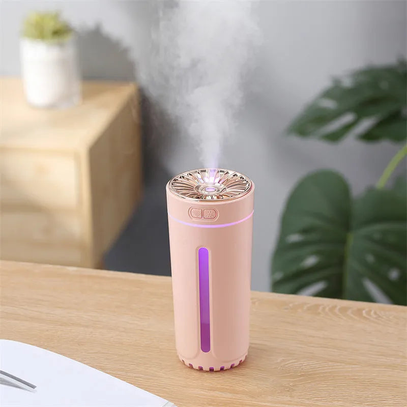 Black wireless portable humidifier with colourful lights beside car cup holder