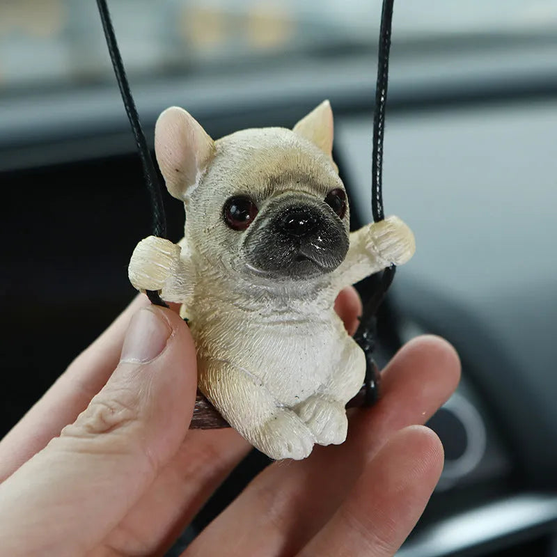 Small resin bulldog cartoon pendant for hanging on a car rearview mirror.