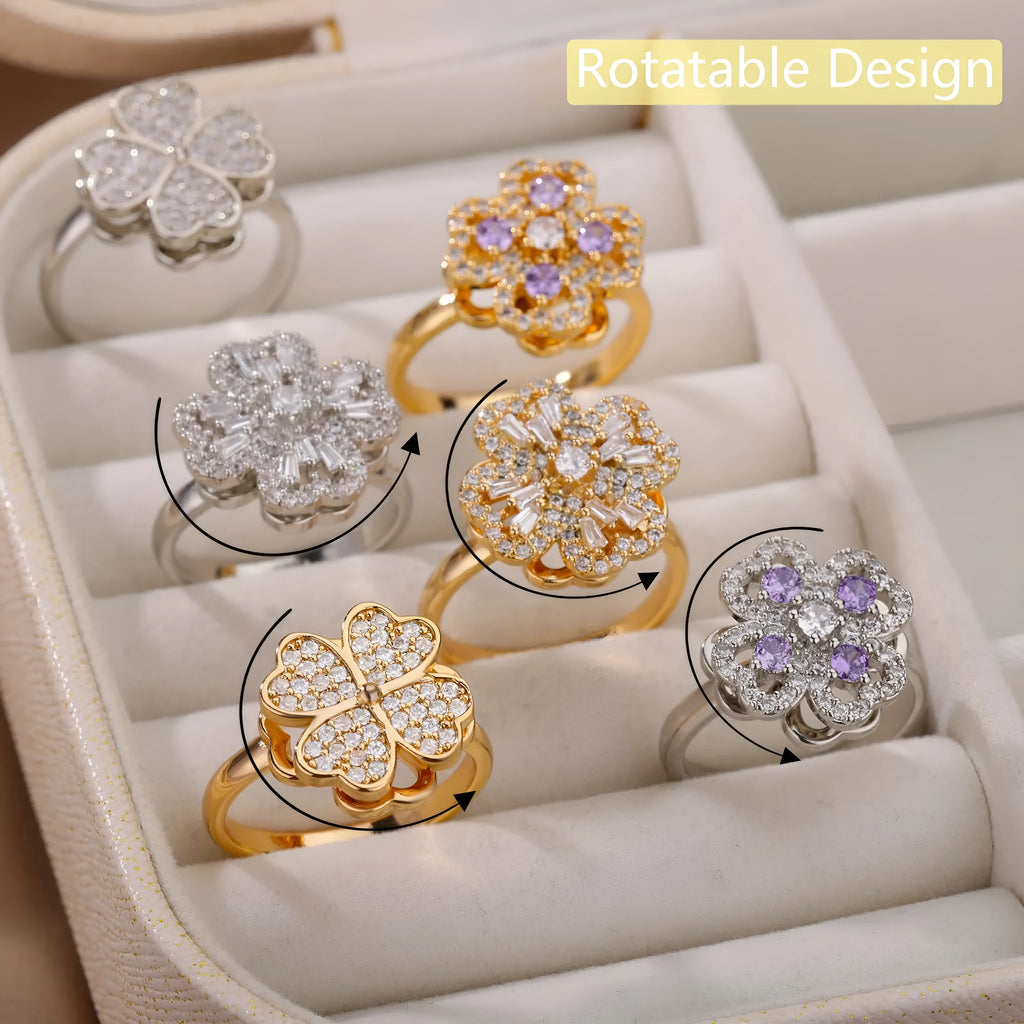 Rotatable flower ring with rhinestones on a woman's finger, available in gold or platinum finish