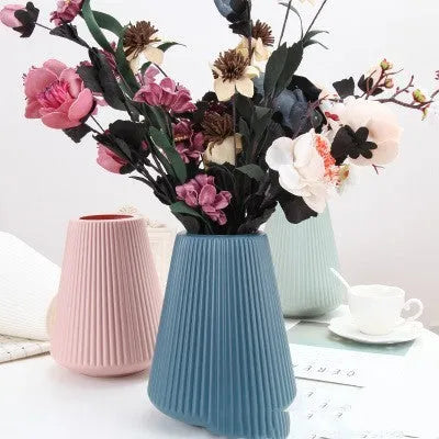 Plastic melamine decorative flower vase in blue colour on wooden surface