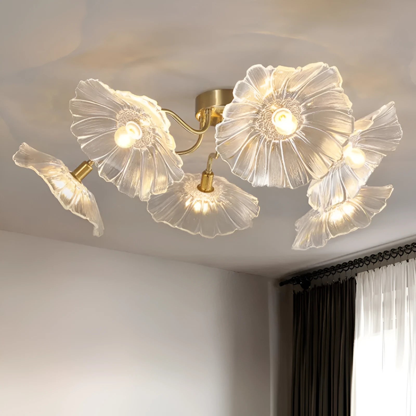Modern ceiling lamp with cluster of artificial white flowers and warm glowing light.