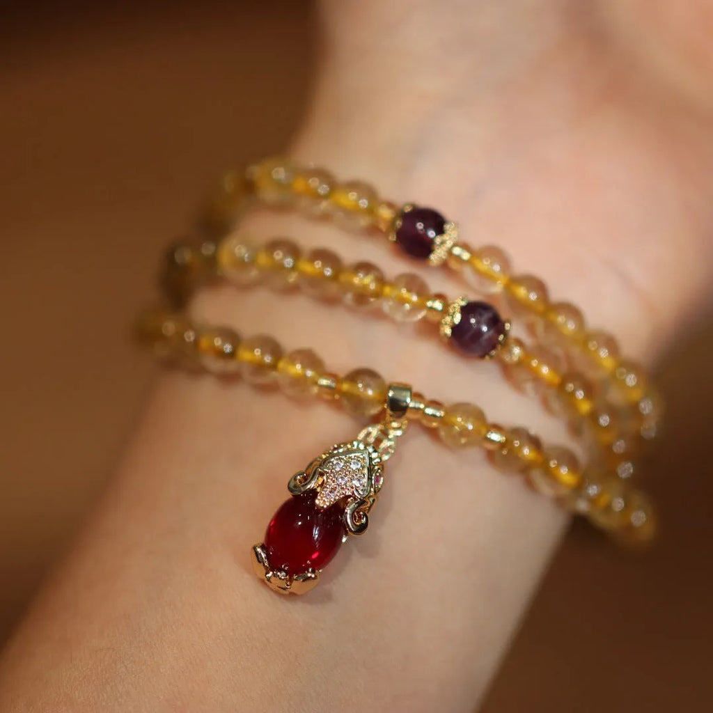 Natural Brazilian rutilated quartz bracelet in Chinese style with three circles and hanging chopsticks.