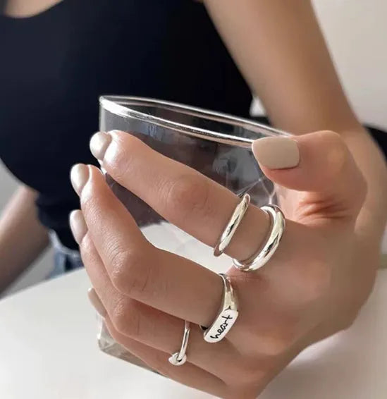 Korean-style 925 sterling silver minimalist ring for women with adjustable opening on a plain background