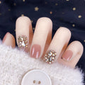 Champagne gold full diamond manicure patches laid out on a surface, showing the sequin finish and adhesive backing