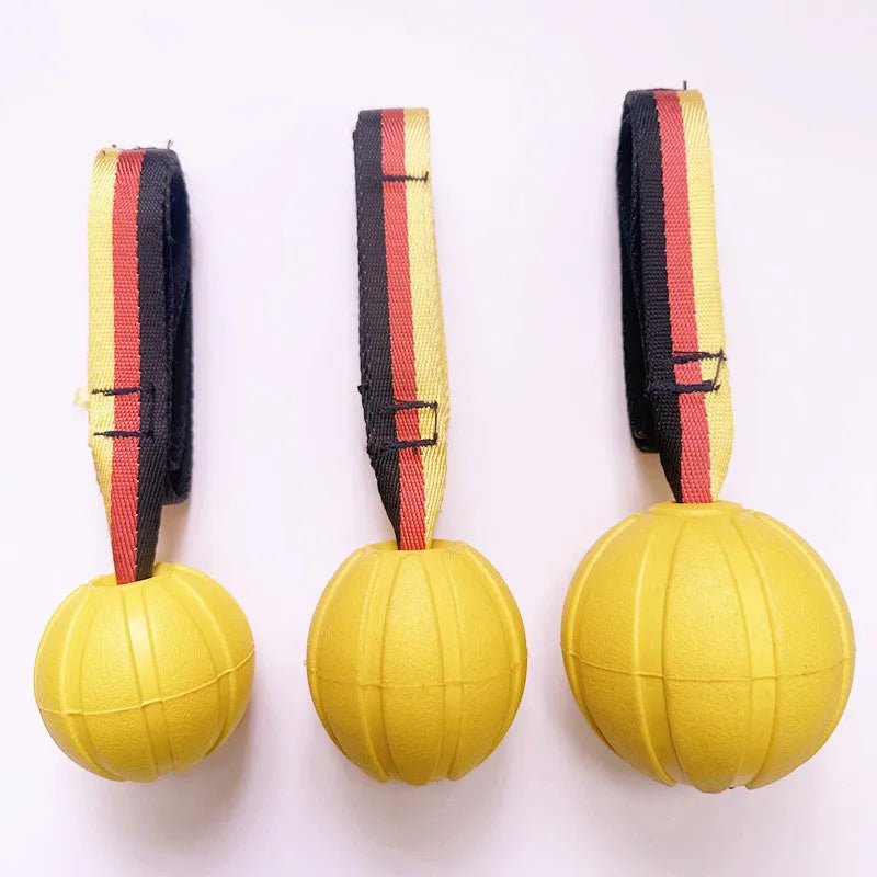 Floating EVA dog training ball with attached string in camouflage and yellow colours, showing three diameter sizes