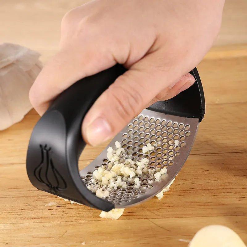 304 stainless steel garlic press in green, pink, black or blue measuring 11cm by 7cm