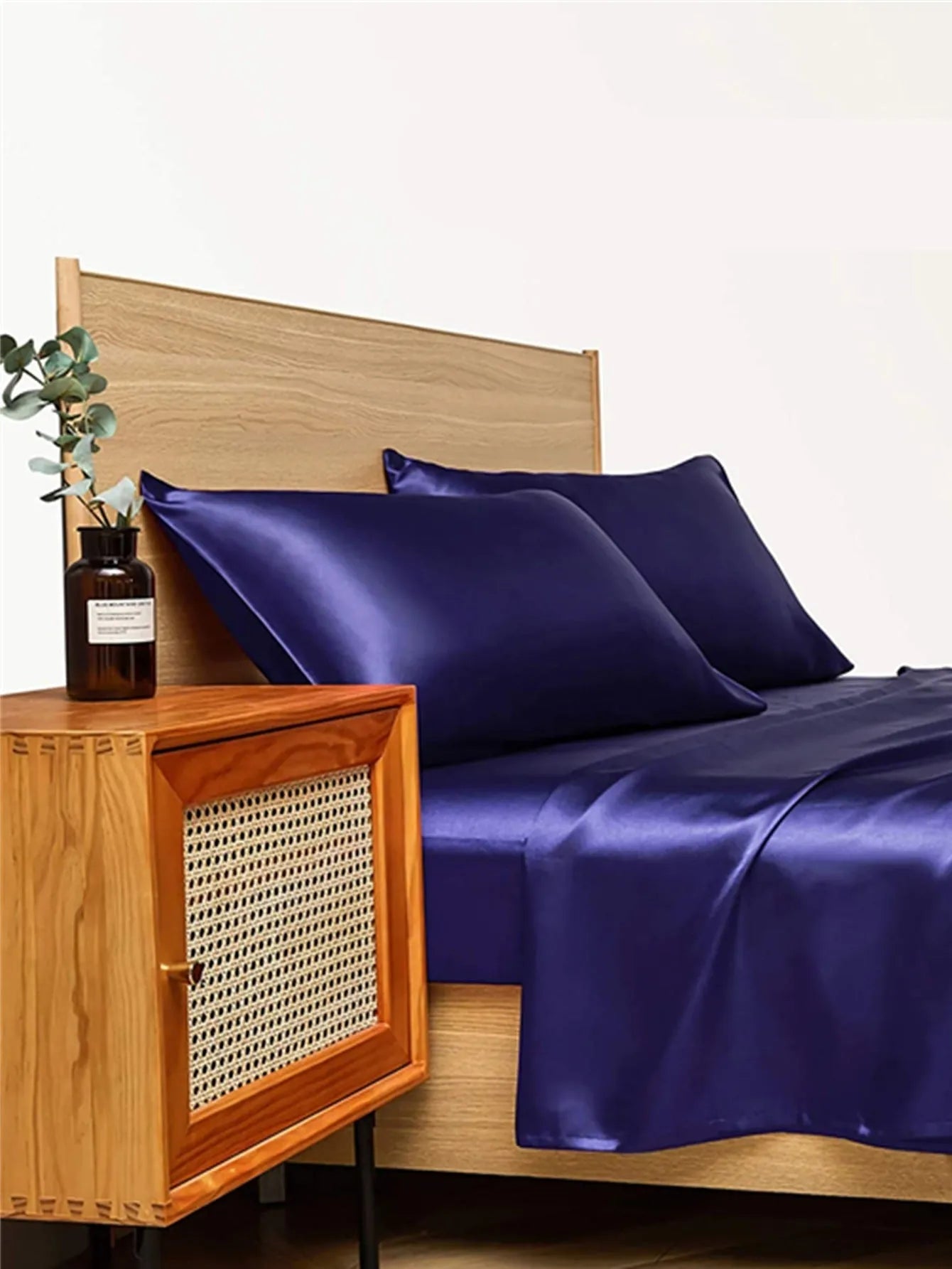 Four-piece imitation silk bedding set with satin weave in Navy Blue on a bed