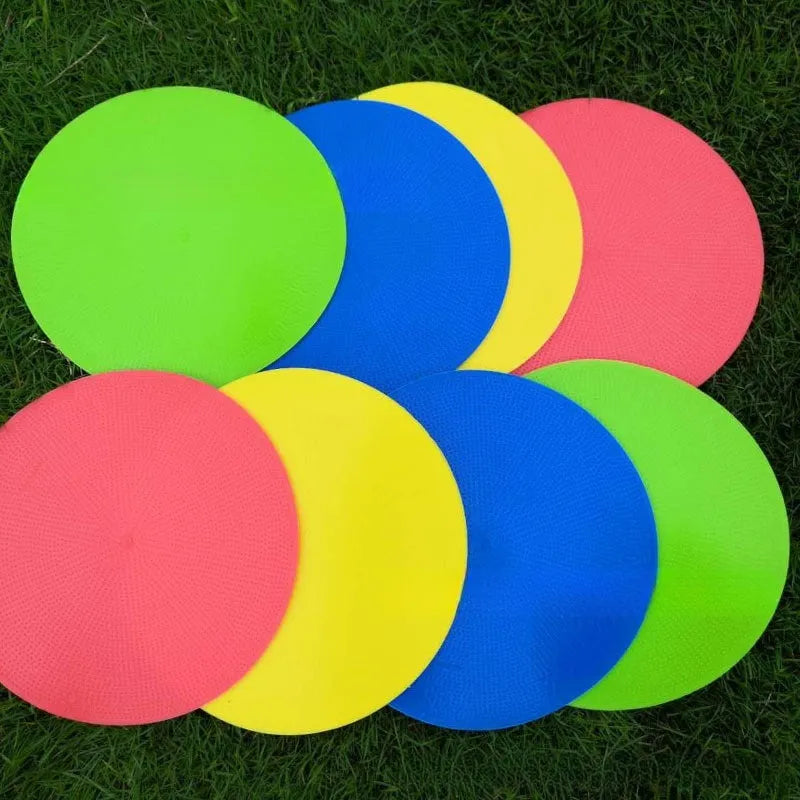Circular yellow football training marker disc on grass field showing 23cm diameter