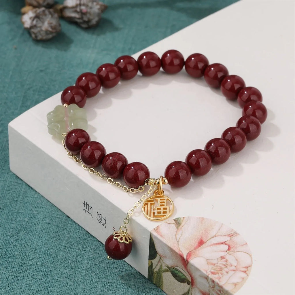 Women's purple gold sand cinnabar bracelet with a fu character charm and peach blossom tassel.