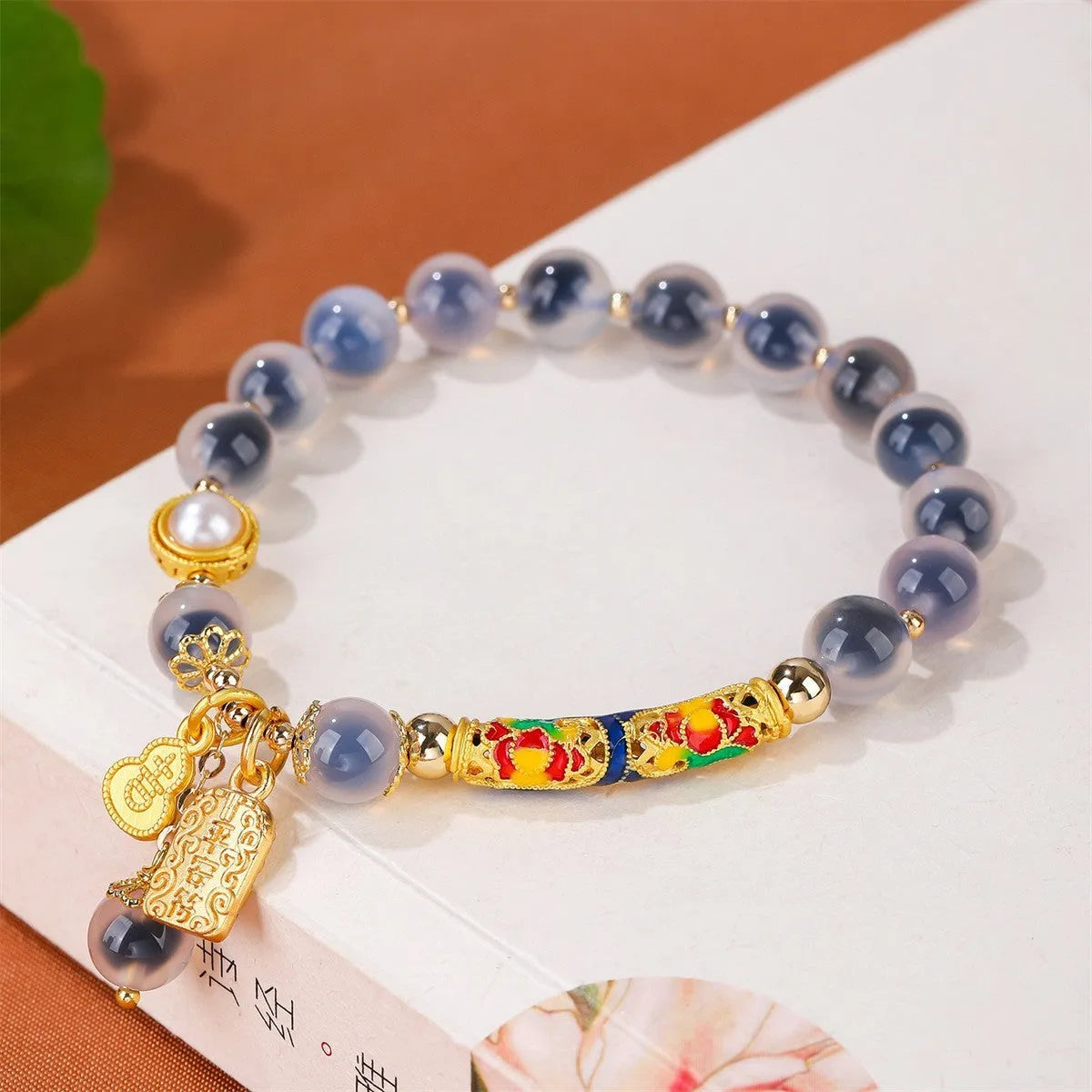 Close-up of a women's sugar heart agate beaded bracelet with an adjustable knot closure on a wrist