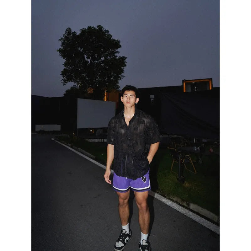 Man's loose-fit short-sleeve shirt with a white and black three-dimensional floral print on heavyweight fabric.