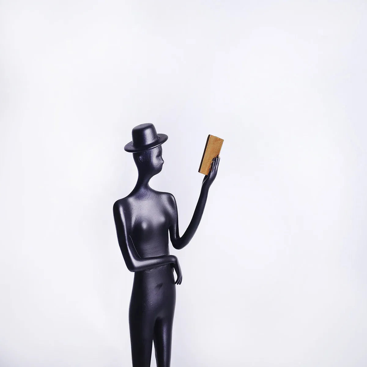 Black aluminium reading woman desktop sculpture with modern geometric design