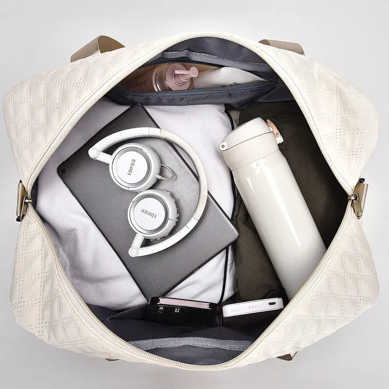 Large Oxford cloth travel bag in a solid colour with sewing thread details.