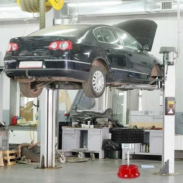 Portable aluminium hub balancer for car wheels with a bull's eye level and enamel-finished base.