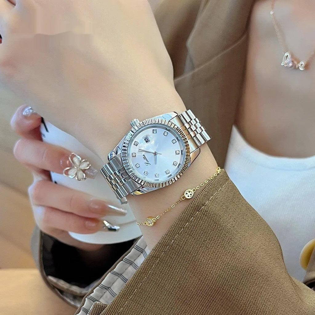 Women's casual quartz watch with solid steel belt, gold case, and white dial with calendar display