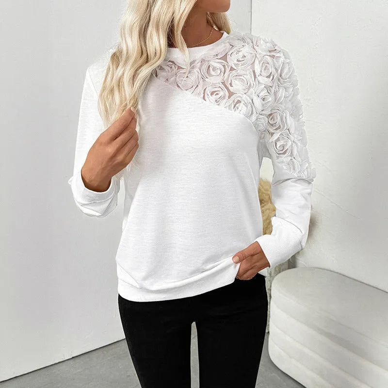 White long sleeve women's top with floral pattern, loose fit pullover style.