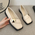 Beige women's square-toe flat shoes with a metal buckle and low rubber sole.