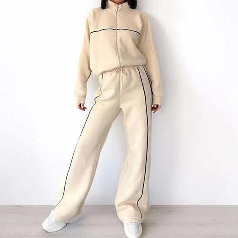 Casual polyester suit set showing a long sleeve mock neck hoodie and striped trousers on a model.