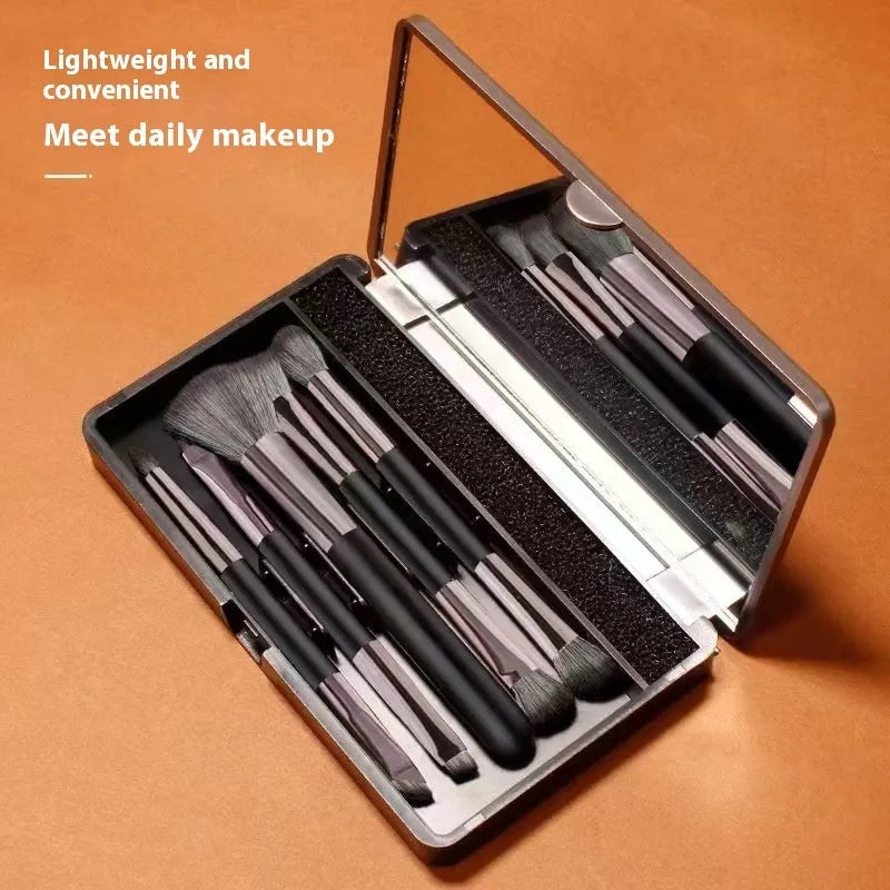 Portable makeup brush set with mirror showing artificial fibre bristles and plastic handles