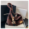 Women's large soft woolen cross-body shoulder bag in a horizontal square shape, shown in a choice of colours.