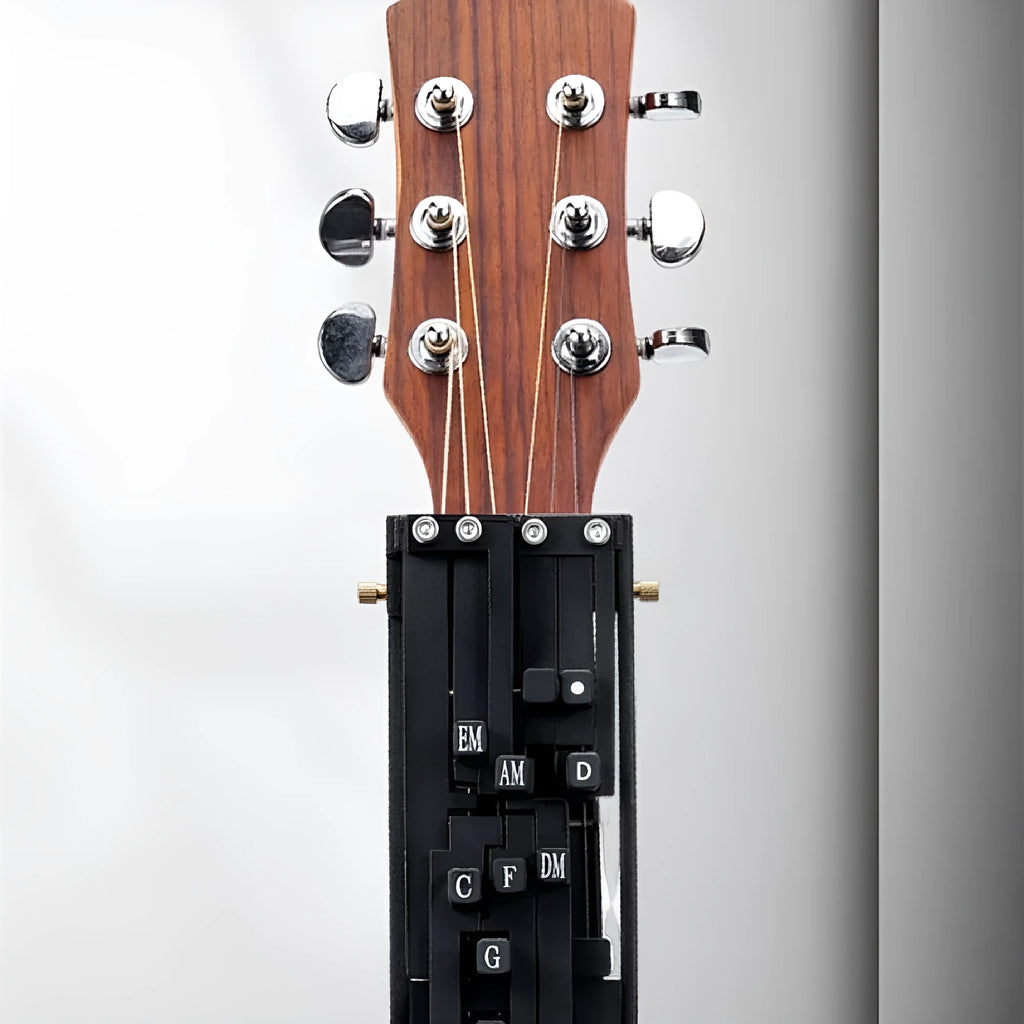 Black automatic chord practice device for novice guitar players attached to acoustic guitar