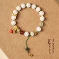 Hand-woven white jade bodhi bracelet with lotus and large pumpkin beads on a single ring open rope.