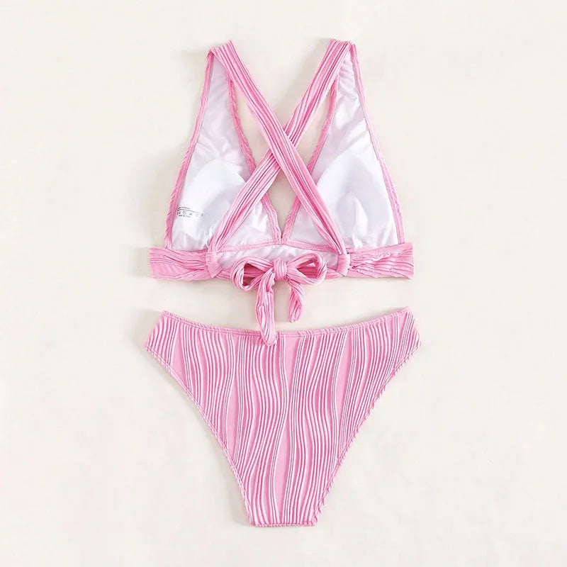 Women's pink halter strap bikini top and shorts swimsuit set on a mannequin.
