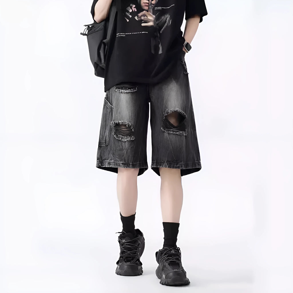 Men's washed denim shorts with ripped detailing in black or blue, showing loose retro style and fifth-pants length
