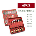 Stainless steel Christmas spoon and fork set with snowman and tree designs on handles